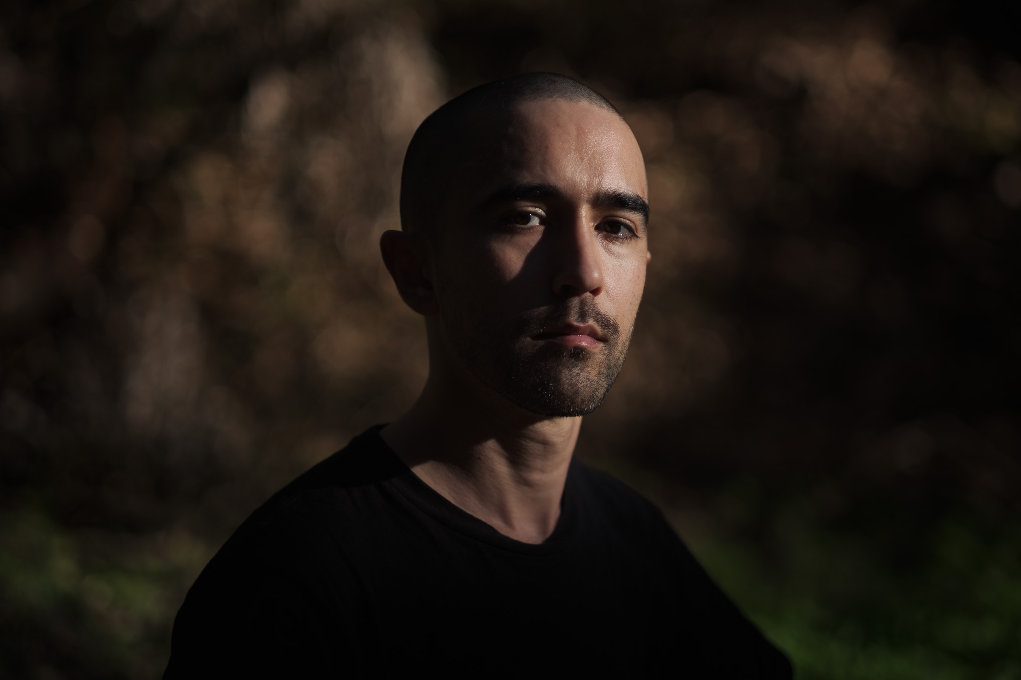 Portrait of Levi Meir Clancy outdoors in dramatic light